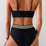 Bikini su graikišku raštu, bustier dizainu su sukryžiuotomis detalėmis ir aukštu liemeniu